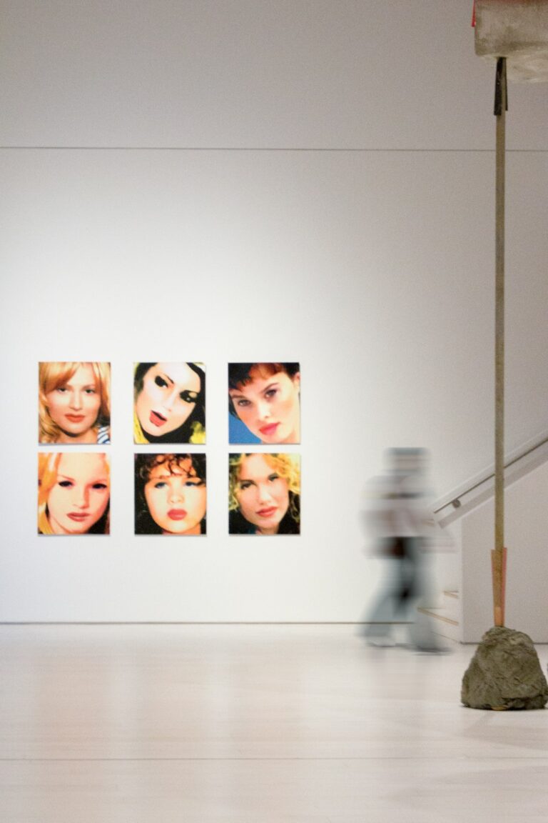 A white room with a bunch of pictures on the wall